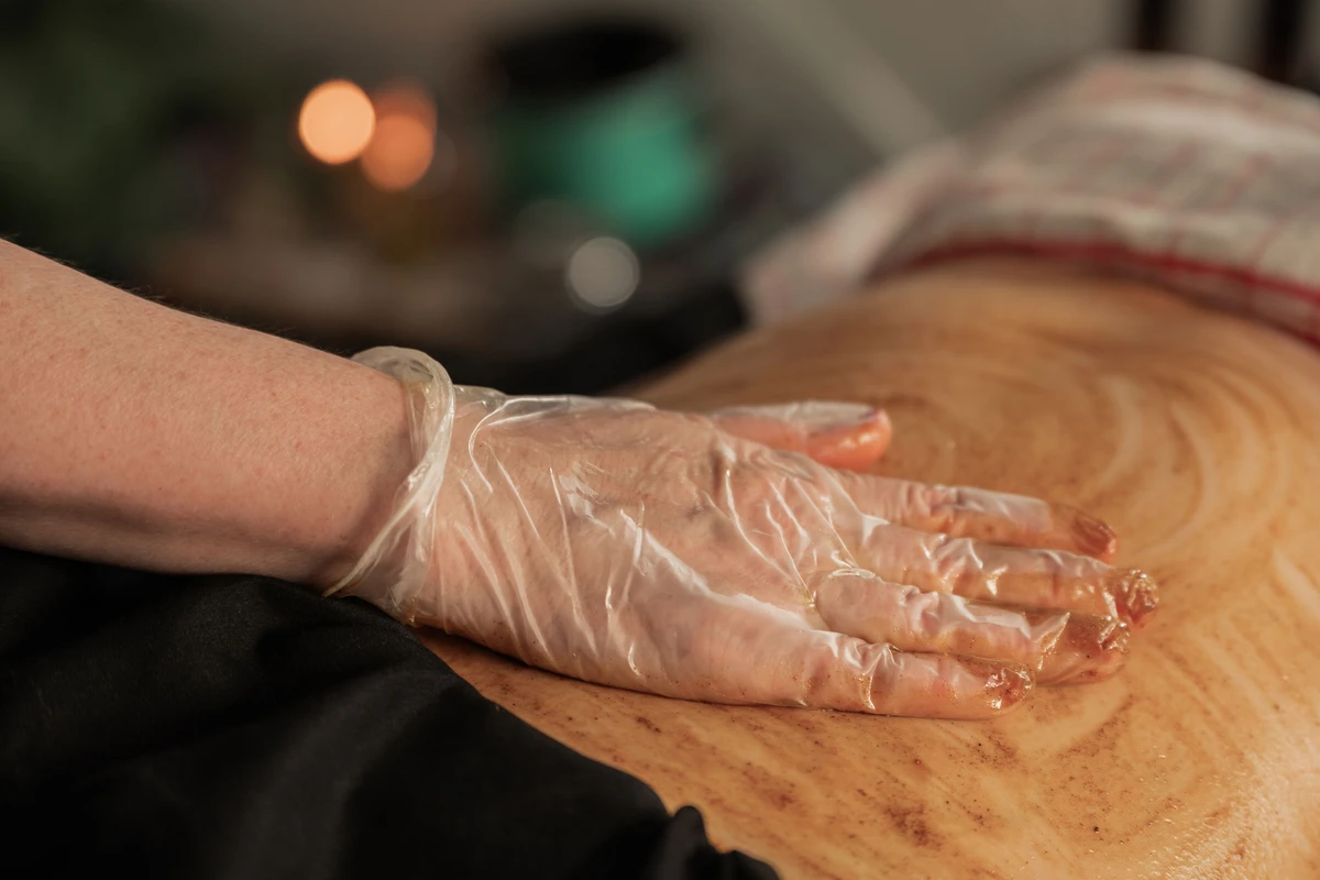 Warming paste being applied for belly binding